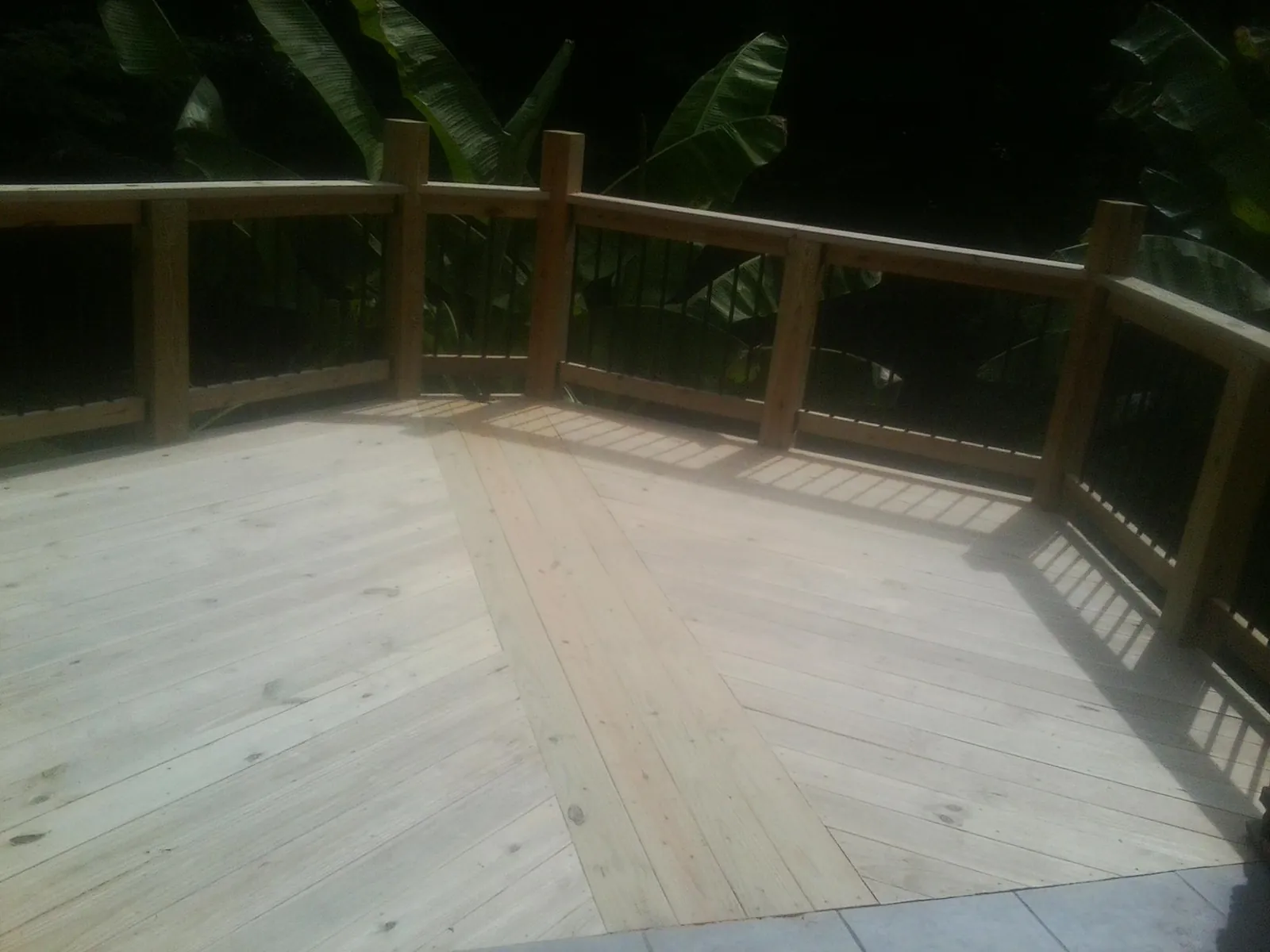 New wood deck and railing built off the back of a home in Centreville
